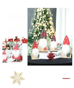 Close-up of wooden Christmas gnomes with red felt hats and white faux fur beards