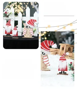 Detail of wooden Santa and owl figurines with flocking accents for Christmas decor