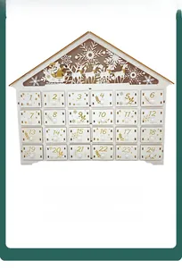 Detail of wooden house Advent Calendar with 24 gold numbered drawers and reindeer cutout