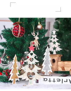 Macro view of decorative wooden Christmas trees with gold glitter and hanging metal hearts