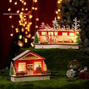 Christmas wooden house with LED lights and festive caravan on mossy surface decoration