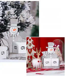 Close-up of wooden Christmas snowman calendar with adjustable date blocks for desk decor