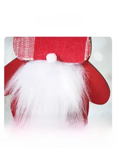 Detail of Christmas gnome ornament with red plaid fabric hat and long white faux fur beard