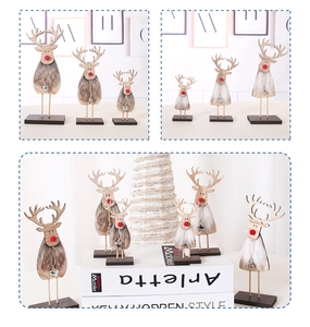 Detail of wooden Christmas reindeer decor with faux fur texture and silver bell accents