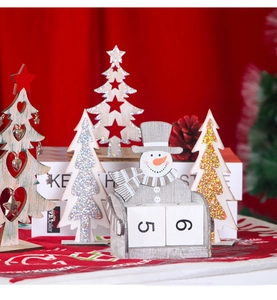 Macro detail of wooden Christmas snowman calendar with number blocks and mini pine trees