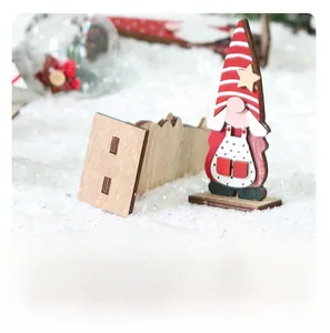 Detail of wooden Christmas gnome ornament with striped hat and snowflake base decoration