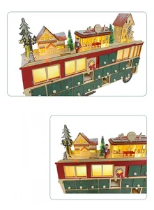 Detail of wooden Christmas bus advent calendar with 24 drawers and LED glowing scene