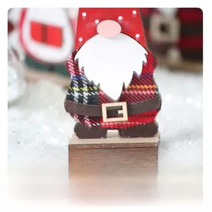 Detail of hand-painted wooden Christmas gnome with red and green plaid clothes