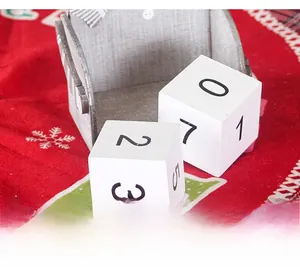 Macro detail of painted wooden advent blocks with numbers in a grey storage box