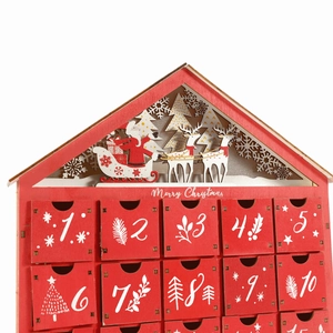 Red wooden Christmas house advent calendar with 24 small drawers and Santa Claus carvings
