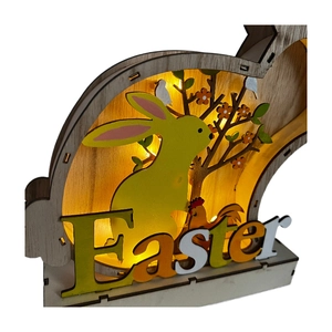 Detail of wooden Easter bunny LED lamp with layered laser-cut scenes and warm yellow light