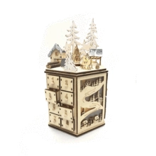 Detail of wooden advent calendar with laser-cut winter village and numbered drawers