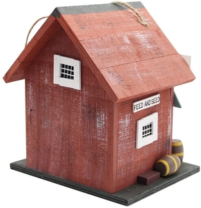 Detail of red wooden birdhouse with barn design, white trim, and rustic rope hanger