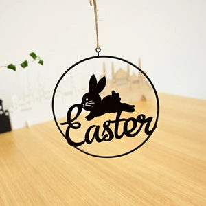 Detail of black metal Easter wreath silhouette featuring bunny and rustic hanging rope