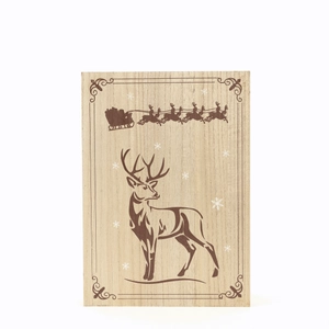 Detail of wooden Christmas countdown ornament with reindeer and Santa engraving