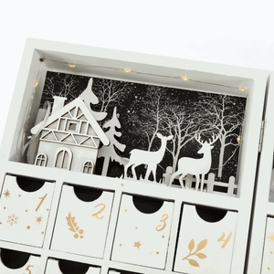 White wooden Christmas advent calendar box with LED winter village and numbered drawers