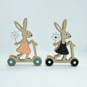 Detail of laser-cut wooden Easter bunnies on scooters with hand-painted floral dresses