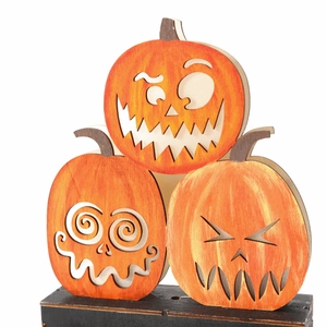 Three-tier stacked wooden Halloween pumpkin decoration with spooky faces on black base