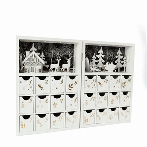 Macro detail of white wooden advent calendar book with 24 drawers and LED forest scene