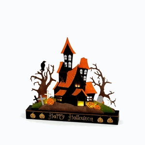 Halloween tiered wooden castle decoration with warm LED lights and pumpkin accents