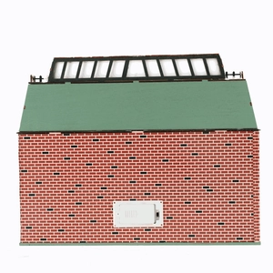 Rear view of the Christmas house showing red brick texture and battery compartment