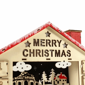 Close-up of wooden Christmas countdown calendar with laser-cut snow scene and glitter clouds