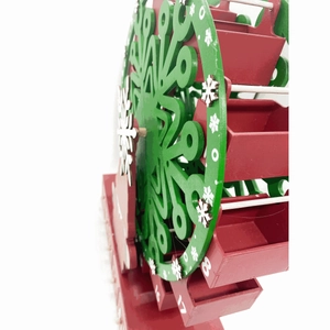 Detailed macro view of wooden Christmas advent calendar Ferris wheel with red numbered boxes