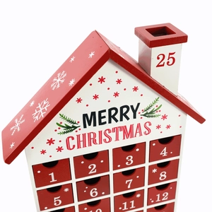 Close-up of wooden house Christmas advent calendar with 24 numbered drawers and chimney