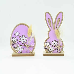 Close-up of Easter wooden ornaments with purple floral hollows and natural dried flowers