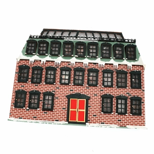 Detail showing the 24-day advent calendar windows on a wooden Christmas house with red bricks