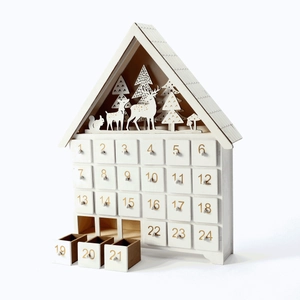 Close-up of wooden advent calendar with LED lights and reindeer forest carvings