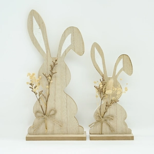 Detail of wooden Easter rabbit figurines with natural dried flowers and rustic jute rope