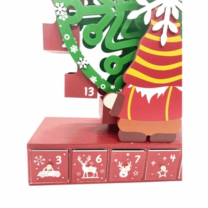 Detail view of wooden Christmas advent calendar drawers with printed numbers and decor