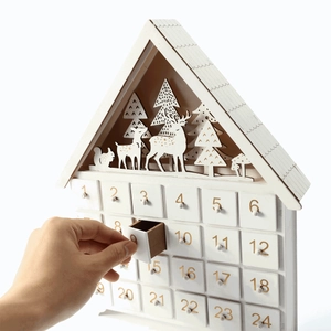 White wooden house Advent calendar with 24 drawers and LED forest scene deer silhouettes