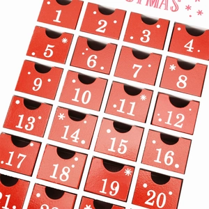 Red wooden Christmas advent calendar house with 24 numbered drawers for candy and gifts