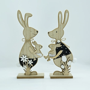 Detail of wooden Easter bunny ornaments with twine bows and floral base decorations