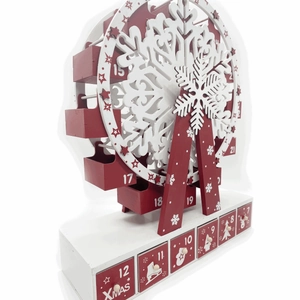 Detailed macro view of a wooden Christmas Ferris wheel advent calendar with mini red drawers