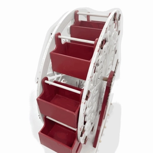 Detail of red and white wooden ferris wheel advent calendar with laser-cut star patterns