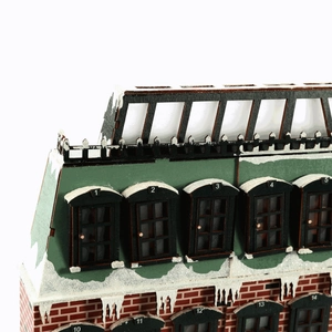 Close-up of wooden Christmas advent calendar with numbered windows and snowy details