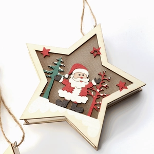 Close-up of laser-cut wooden star ornament featuring Santa Claus and pine trees