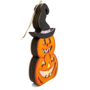 Detail of layered wooden Halloween pumpkin light with witch hat and warm LED glow