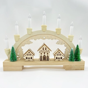 Detail of wooden Christmas LED bridge with laser-cut houses and seven electric candles