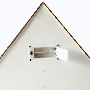 Rear view of white house advent calendar showing LED battery compartment and power switch