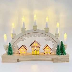 Detail of wooden Christmas candle bridge with LED lights and festive miniature house scene
