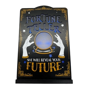 Detail of illuminated wooden Halloween Fortune Teller sign with blue glitter and glowing ball