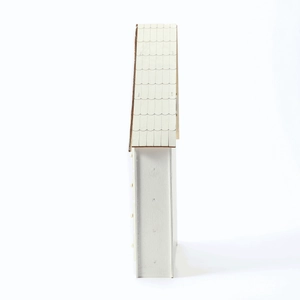 Detail of white wooden house advent calendar with festive fish scale roof textures