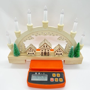 Detailed view of a wooden Christmas bridge light on a scale weighing 476.8g