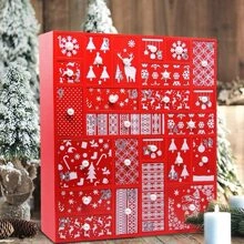 Detail of red wooden advent calendar drawers with festive white holiday patterns