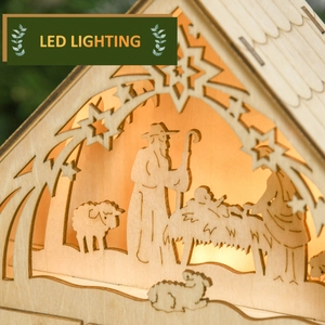 Detail of laser-cut wooden nativity scene decoration with warm glowing LED lighting