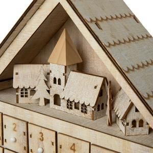 Macro detail of wooden Christmas advent calendar with miniature houses and numbered drawers